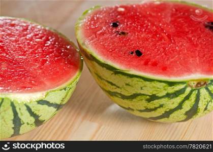 fresh ripe watermelon sliced on a wood table