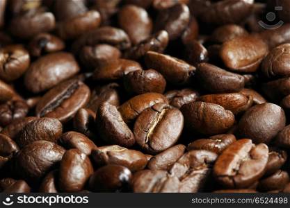 Fresh roasted coffee beans close-up background. Roasted coffee beans