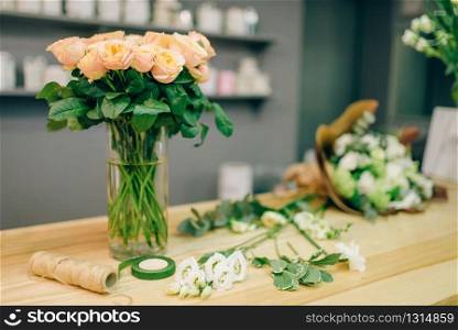 Fresh rose bouquet composition in flower boutique, nobody. Floral business, florist workplace in shop