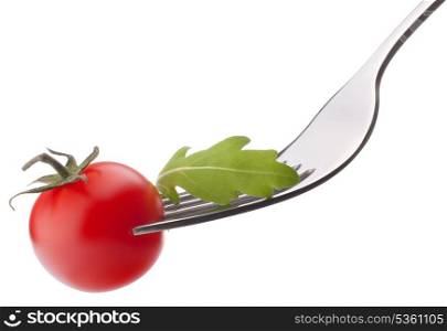 Fresh rucola salad and cherry tomato on fork isolated on white background cutout. Healthy eating concept.