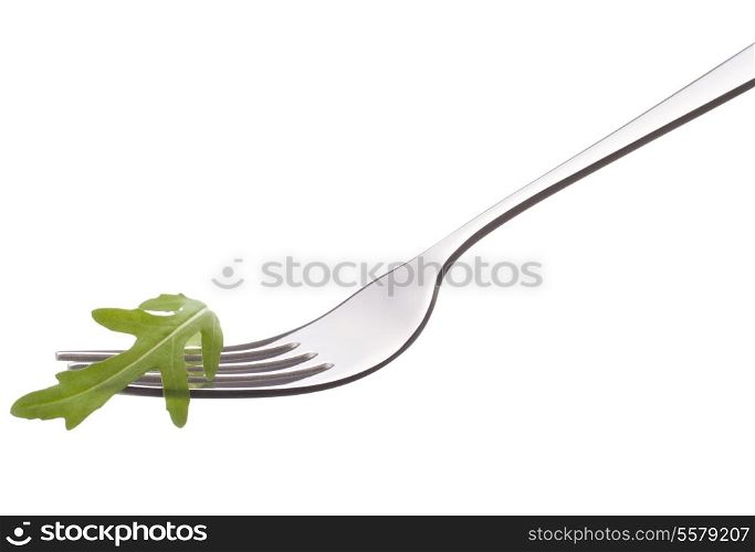 Fresh rucola salad on fork isolated on white background cutout. Healthy eating concept.