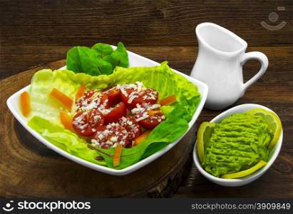 Fresh salad, avocado with lemon and green beans. Wooden background.