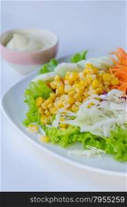 fresh salad. fresh salad with fruits and mixed vegetable on dish served with white cream sauce