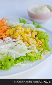 fresh salad. fresh salad with fruits and mixed vegetable on dish served with white cream sauce