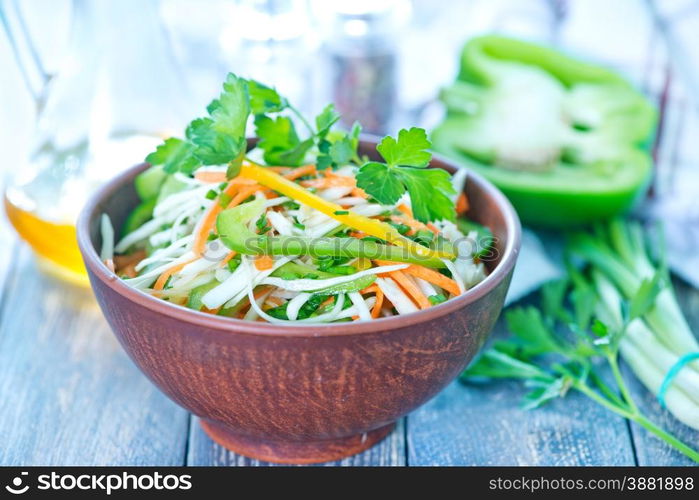 fresh salad in bowl and on a table