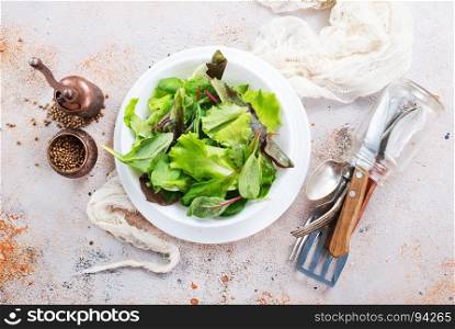 fresh salad in bowl and on a table
