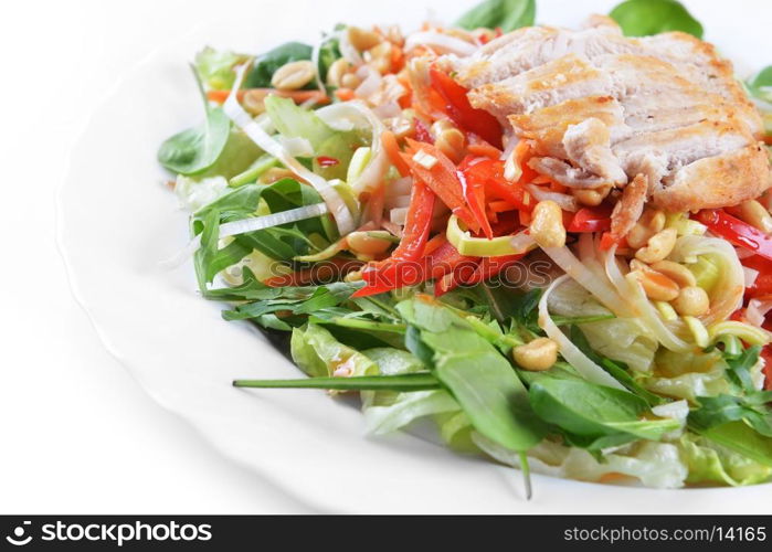 fresh salad of fried chicken, spinach and nuts