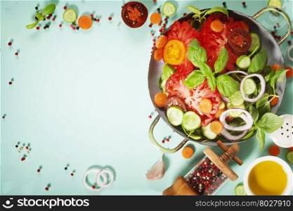 Fresh salad on blue background - Tomatoes, onion, carrot, basil, cucumbers, salt and pepper. Top view