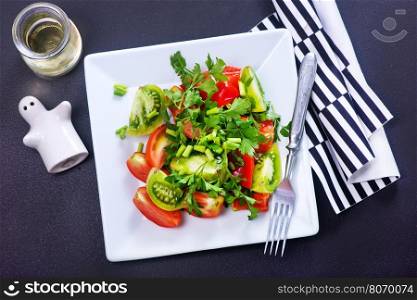 fresh salad on plate and on a table