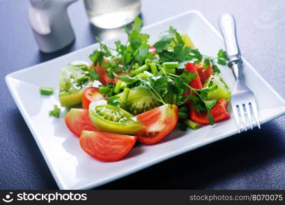 fresh salad on plate and on a table