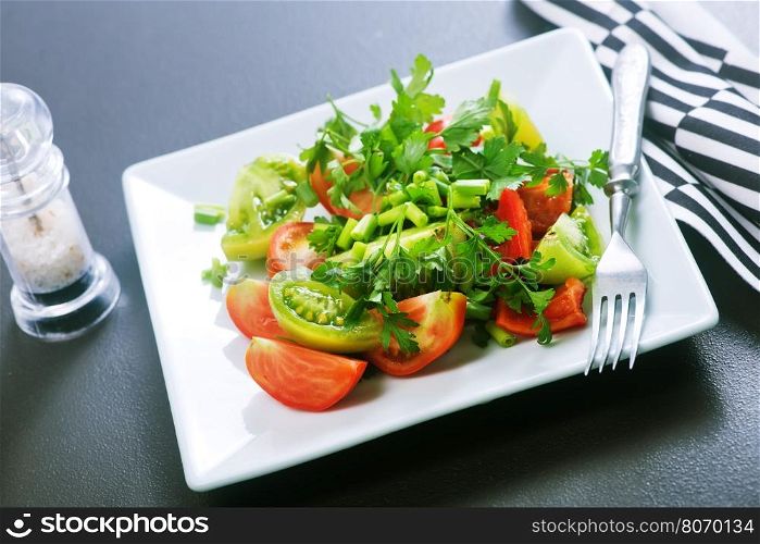 fresh salad on plate and on a table