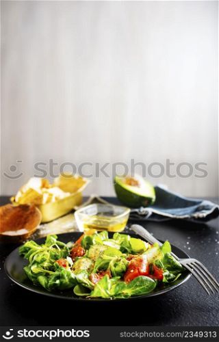 Fresh salad with avocado, cucumber, salmon. Dressing with honey, dijon mustard, olive oil and lemon juice