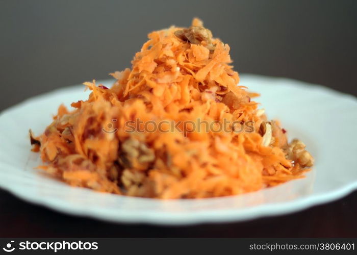 Fresh salad with carrot, apples and walnuts. Shallow depth of field.