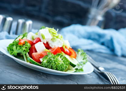 fresh salad with feta cheese on the plare