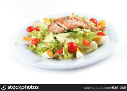 Fresh salad with lettuce, cherry tomato and meat on dish