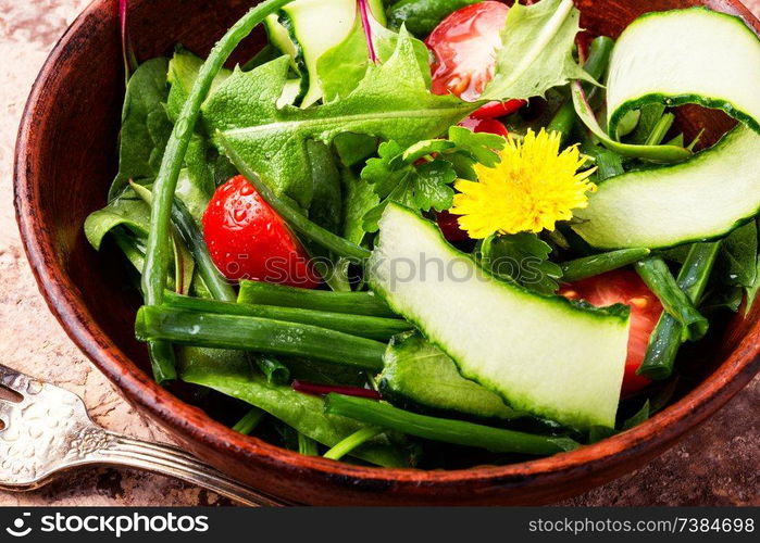 Fresh salad with mixed greens.Healthy food.Vegetable salad with fresh lettuce. Spring salad with dandelions