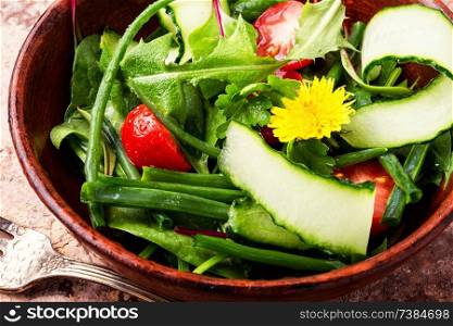 Fresh salad with mixed greens.Healthy food.Vegetable salad with fresh lettuce. Spring salad with dandelions