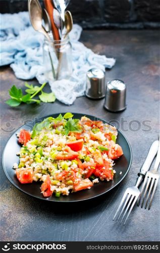 fresh salad with tomato and shrimps on the plate