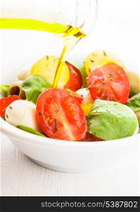 Fresh salad with tomatoes, mozzarella and olive oil
