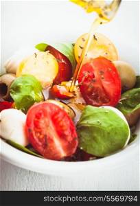 Fresh salad with tomatoes, mozzarella and olive oil