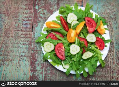 Fresh salad with tomatoes, rucola and cucumbers
