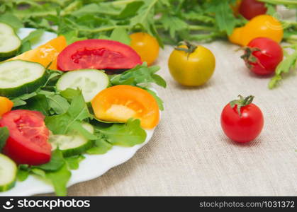 Fresh salad with tomatoes, rucola and cucumbers