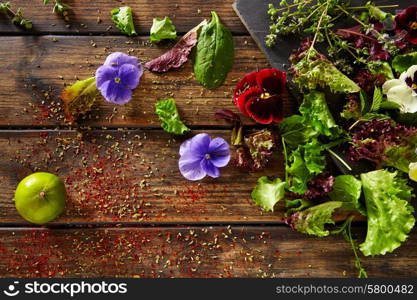 Fresh saland ingredients lettuce flowers spinach on rustic wood