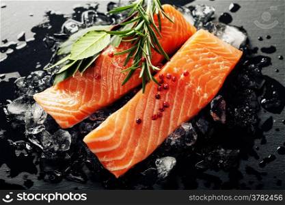 Fresh salmon with herbs and spices - healthy food, diet and cooking concept