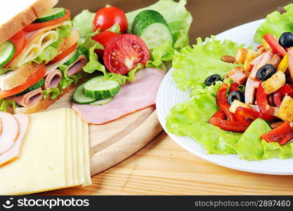 Fresh sandwich and tasty salad on plate, close up