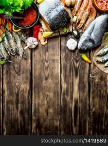 Fresh seafood. A variety of seafood from shrimp, shellfish and other marine life. On wooden background.. variety of seafood from shrimp, shellfish and other marine life.
