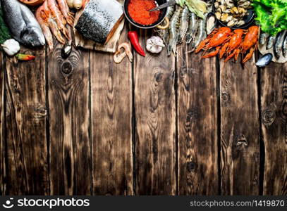 Fresh seafood. A variety of seafood from shrimp, shellfish and other marine life. On wooden background.. variety of seafood from shrimp, shellfish and other marine life.