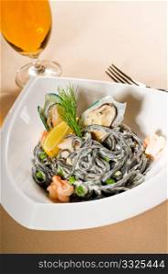 fresh seafood black squid ink coulored spaghetti pasta tipycal italian food