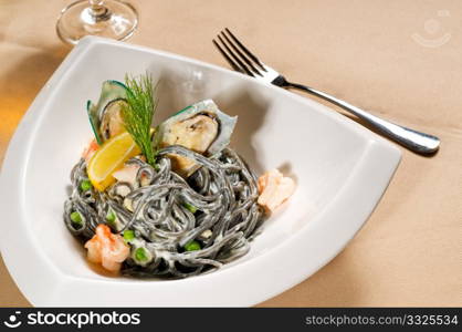 fresh seafood black squid ink coulored spaghetti pasta tipycal italian food