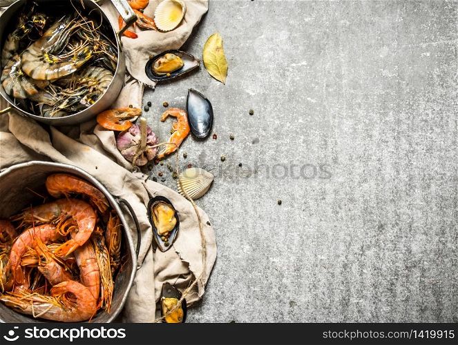 Fresh seafood. Fresh shrimp, fish and shellfish. On a stone background.. Fresh shrimp, fish and shellfish.