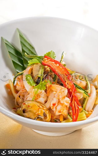 fresh seafood thai style salad with glass noodles on a bowl close up