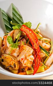 fresh seafood thai style salad with glass noodles on a bowl close up