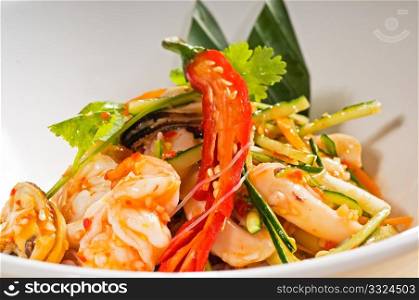 fresh seafood thai style salad with glass noodles on a bowl close up