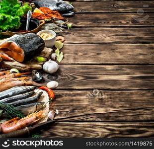 Fresh seafood. Variety of seafood shrimp, fish, and shellfish. On wooden background. Variety of seafood shrimp, fish, and shellfish.