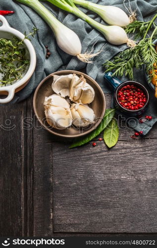 Fresh seasoning ingredients on rustic wooden background, top view, border