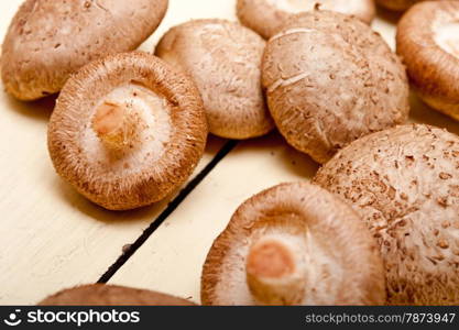 fresh shiitake mushrooms on a rustic wood table