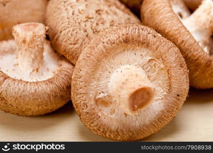 fresh shiitake mushrooms on a rustic wood table