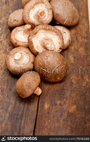 fresh shiitake mushrooms on a rustic wood table