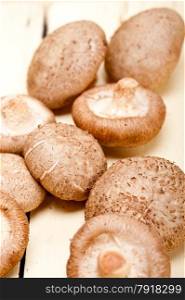 fresh shiitake mushrooms on a rustic wood table