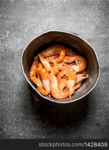 Fresh shrimp in the old pot. On a stone background.. Fresh shrimp in the old pot.