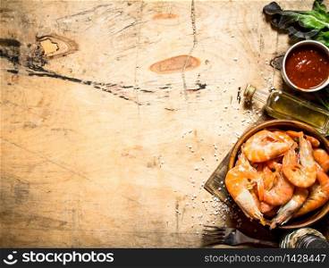 Fresh shrimp with sauce. On a wooden table.. Fresh shrimp with sauce.