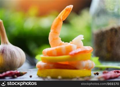 fresh shrimps on lemon served on plate / seafood boiled peeled shrimp prawns cooked with spices and vegetable , beautiful food