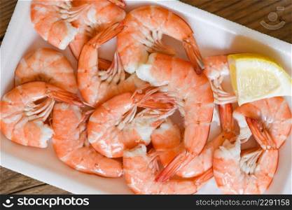 Fresh shrimps on on plate plastic tray with lemon, boiled shrimp prawns cooked food in the seafood restaurant