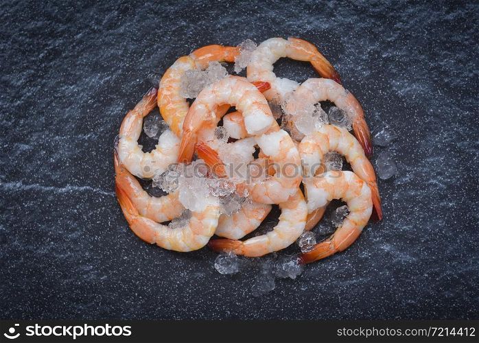 fresh shrimps served on ice in the dark plate / boiled peeled shrimp prawns cooked with spices in the seafood restaurant
