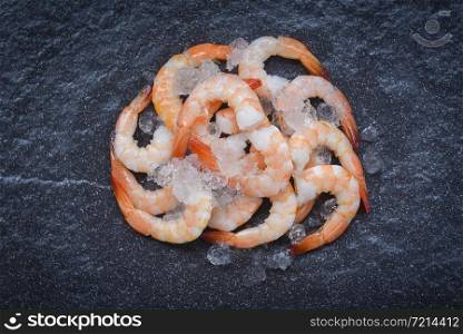 fresh shrimps served on ice in the dark plate / boiled peeled shrimp prawns cooked with spices in the seafood restaurant
