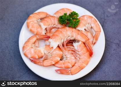 Fresh shrimps served on white plate with parsley, boiled peeled shrimp prawns cooked in the seafood restaurant